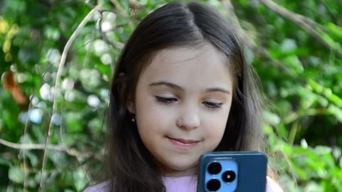 Child is using mobile phone. Kid is looking at screen of devices Video stock 282860871