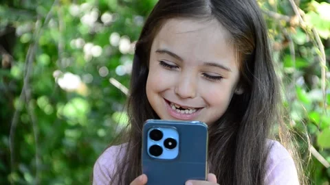 Child is using mobile phone. Kid is looking at screen of devices Video stock 282860878