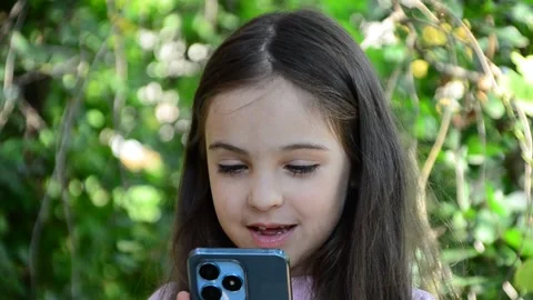 Child is using mobile phone. Kid is looking at screen of devices Video stock 282860879