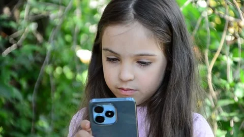 Child is using mobile phone. Kid is looking at screen of devices Video stock 282860886