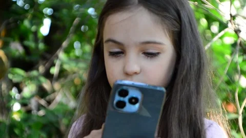 Child is using mobile phone. Kid is looking at screen of devices Video stock 282860888