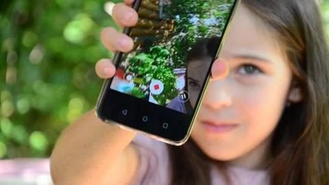 Child is using mobile phone. Kid is looking at screen of devices Video stock 282860900