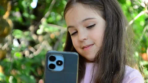 Child is using mobile phone. Kid is looking at screen of devices Video stock 282860902