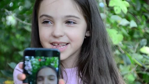 Child is using mobile phone. Kid is looking at screen of devices Video stock 282860932