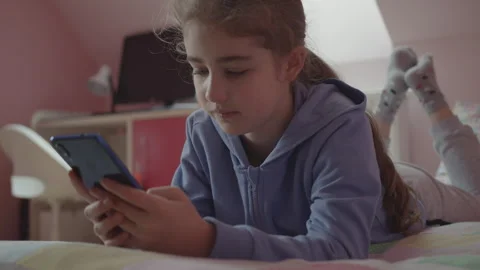 Child Using Mobile Phone Writes Messages in Chat at Home. Teen Girl Watchin.. Stock Footage 281659424