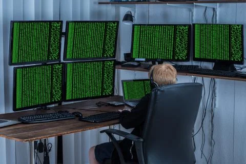 Child Using Multiple Computers With Binary Code On Screen Stock Photos
