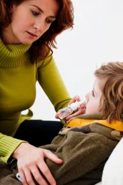 Child using nose spray Stock Photos