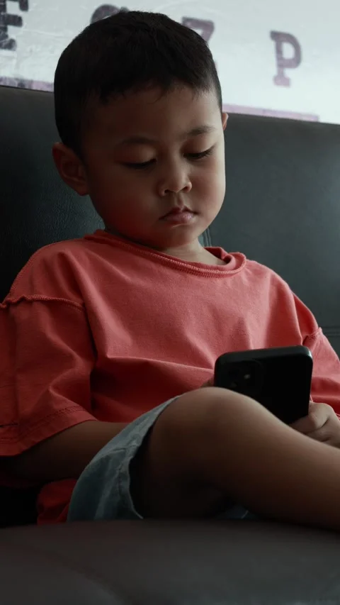 Child using phone on sofa at home Stock-Footage 333888664