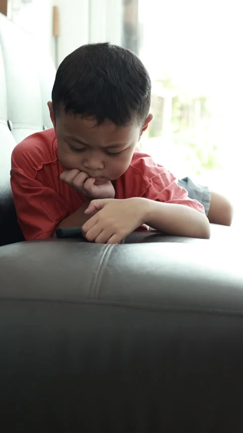 Child using phone on sofa at home Stock-Footage 333888666
