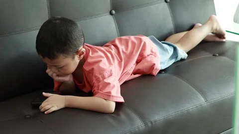 Child using phone on sofa at home Stock-Footage 333888732