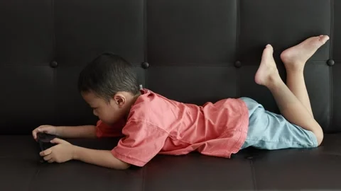 Child using phone on sofa at home Stock-Footage 333888911