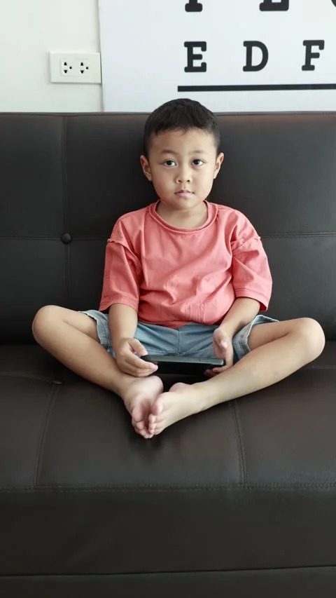Child using phone on sofa at home Stock-Footage 333888913