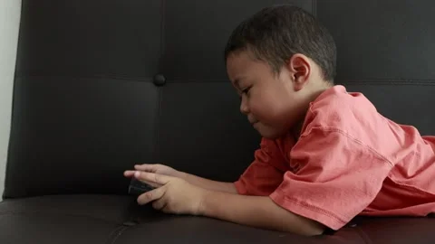Child using phone on sofa at home Stock-Footage 333888976