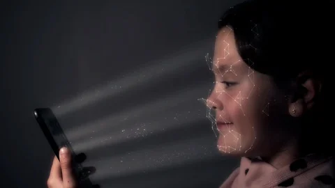 Child using smart phone as it scans her face using facial recognition technology Stock Footage 97079531