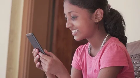 Child Using Smartphone Sending Messages to Friends Girl Playing Games smiling Stock Footage 128502241