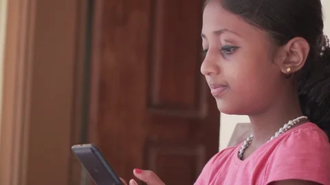 Child Using Smartphone Sending Messages to Friends Girl Playing Games smiling Stock Footage 128502555