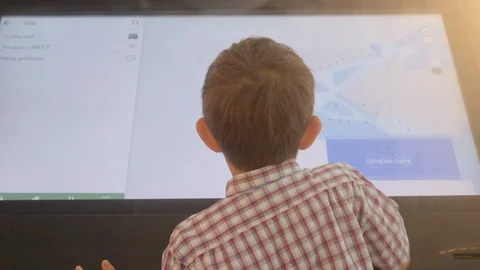 Child is using a touch screen of interactive information stand Stock Footage 111413557