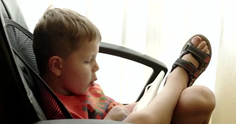 Child Using Touchpad While Playing Video Games Sitting in the Office Chair Stock Footage 64857212