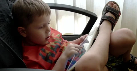 Child Using Touchpad While Playing Video Games Sitting in the Office Chair 스톡 동영상 64857302