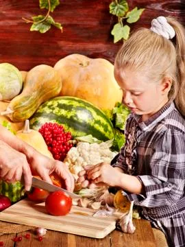 Child with vegetable on kitchen. Stock-Fotos