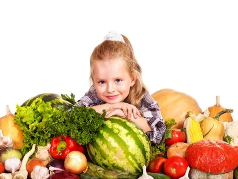 Child with vegetable on kitchen. Stock-Fotos