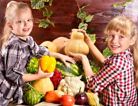 Child with vegetable on kitchen. Foto stock