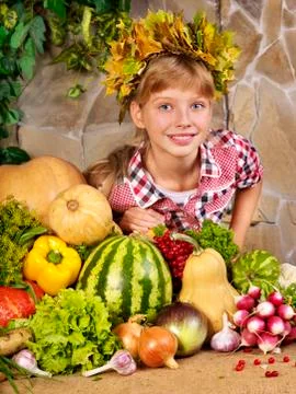 Child with vegetable on kitchen. Stock Photos