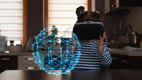 Child with virtual reality headset sitting behind table indoors at home Vidéo 105301719