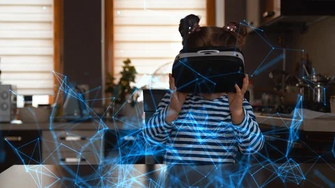 Child with virtual reality headset sitting behind table indoors at home Vidéo 105341058