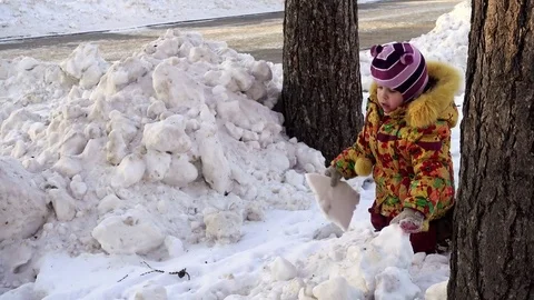Child on a walk in the winter park. Stock Footage 85459989