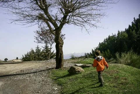 Child walking alone at a path on mountain.Greece. Stock Photos