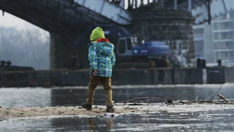Child Walking Along the River Bank Stock Footage 80290964