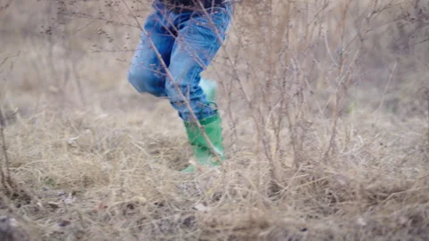 Child Walking In Dry Grass To The Edge Of The Water Stock Footage 300648978
