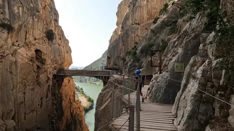 Child walking past massive cliffside Caminito del Rey Video stock 220741282