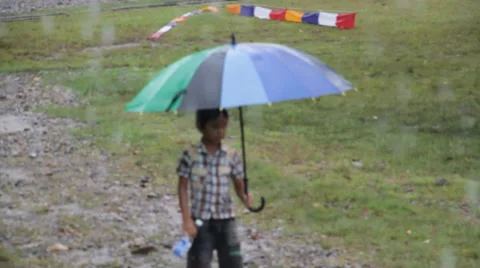 Child Walking in Rain, Indonesia Stock Footage 32283985