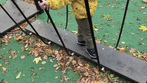 A child walking on the rope path in the park Stock Footage 297740188