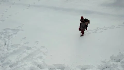 Child walking in snow Stock Footage 267031196