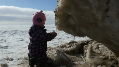 Child walking at winter day. Kid playing outdoor at winter sunny day Stock Footage 102447504