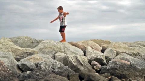 Child walks on the beach breakwaters Stock Footage 65118089