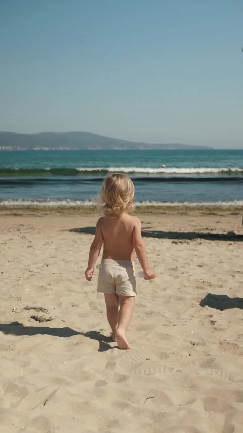 Child walks at beach Stock Footage 307718285