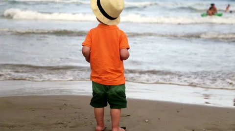 The child walks down the beach towards the sea Stock Footage 54501471