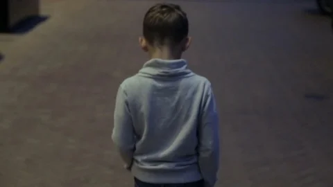 The child walks through the night city Stock Footage