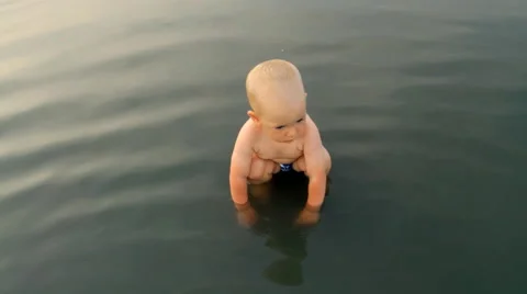 A Child Walks Through a Puddle Stock Footage 64764641