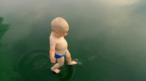 A Child Walks Through a Puddle Video stock 64767184