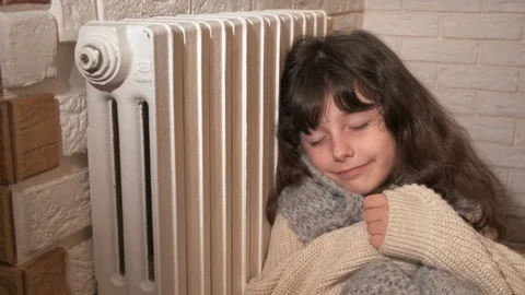 Child in warm clothes by battery. Stock Footage 252151535