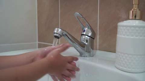 Child washes hands in the bathroom. Stock Footage 213256527