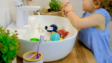 The child washes his hands with soap and water. Selective focus. Stock Footage 237363512