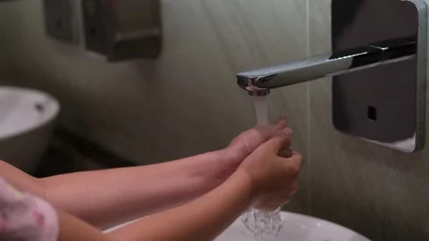 The child washes his hands under the tap. Stock Footage 161868864