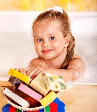 Child washing in bubble bath . Stock-Fotos