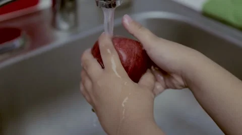 Child Washing fruit Stock Footage 49387624